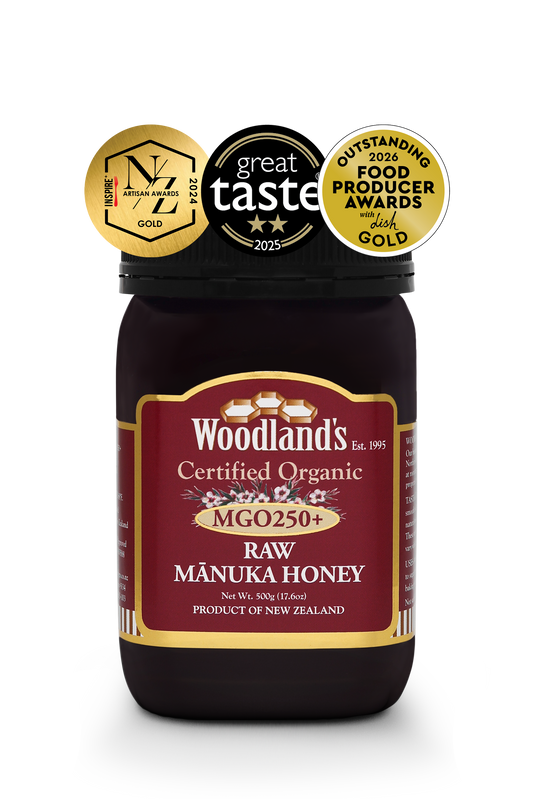 Organic raw Mānuka honey from WellNest in a 500g jar, featuring OFPA Silver and Gold labels, showcasing rich, golden honey.