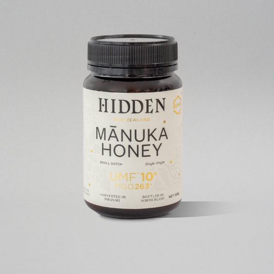 WellNest UMF10+ Manuka Honey jar showing the 500g container with the label and golden honey inside.