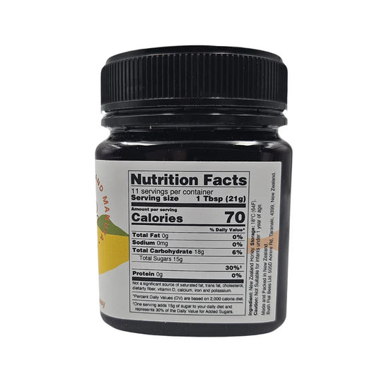 Jar of WellNest Manuka Honey UMF10+ with MGO263+, showing the honey's golden color and label on a white background.