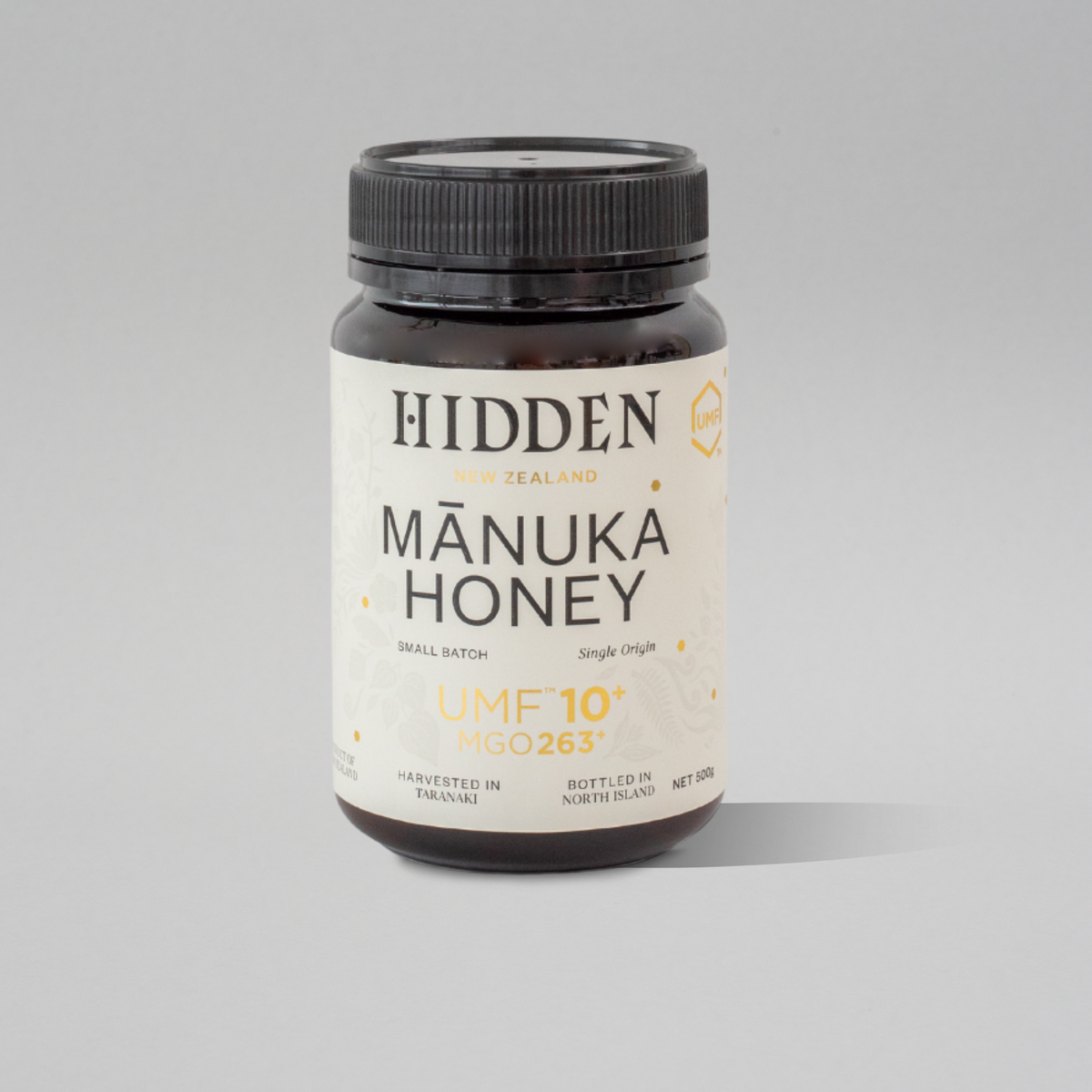 WellNest UMF10+ Manuka Honey jar showing the 500g container with the label and golden honey inside.