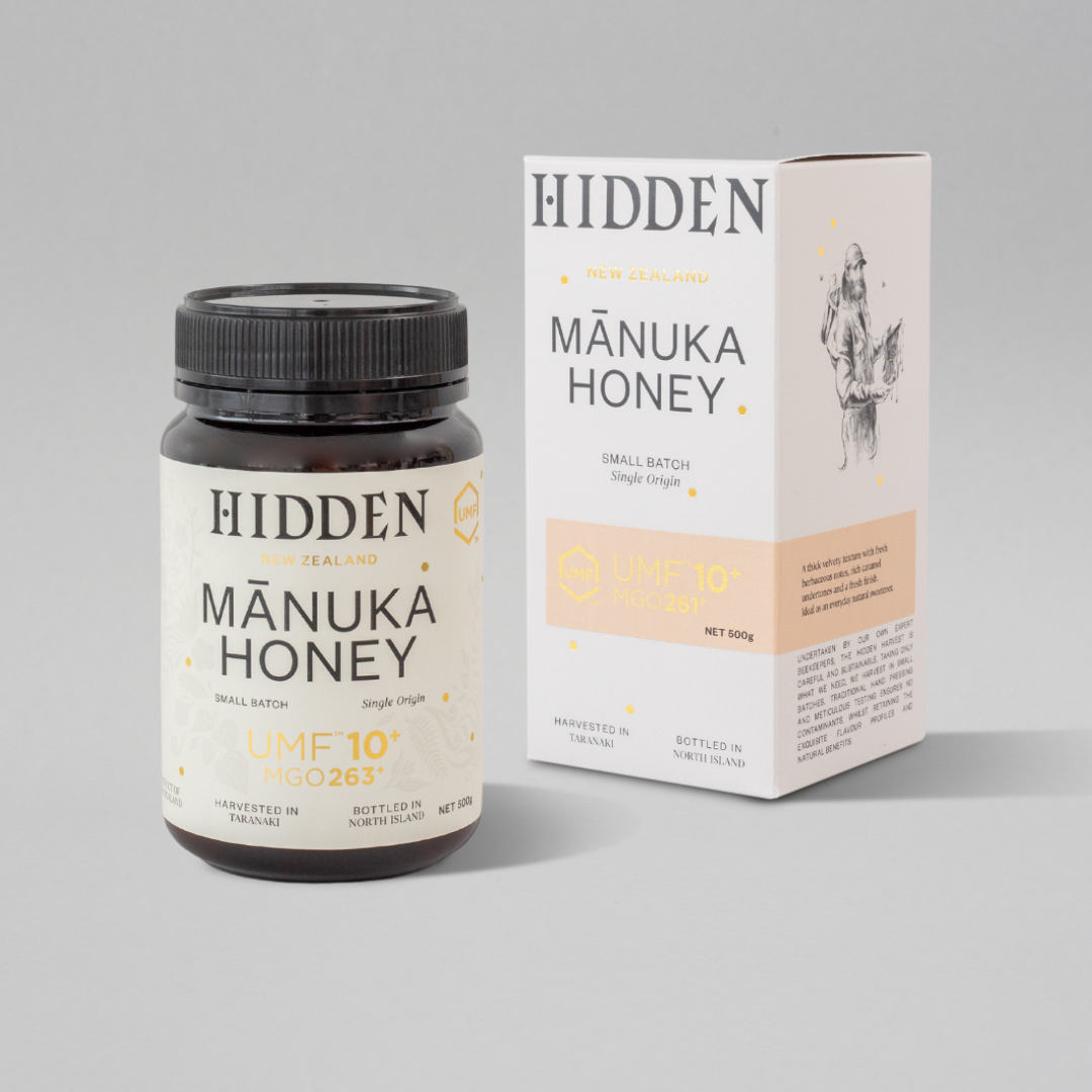 WellNest UMF10+ Manuka Honey in 500g jar, showing golden, viscous honey with UMF and MGO labels for health benefits.