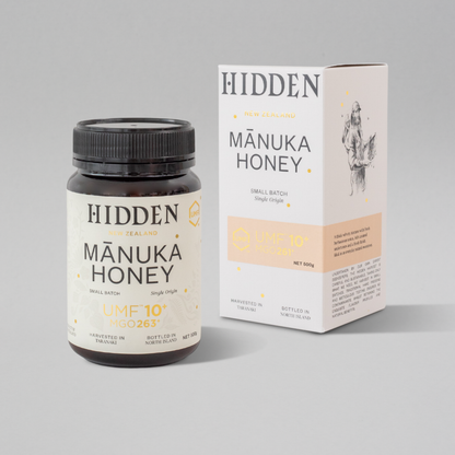 WellNest UMF10+ Manuka Honey in 500g jar, showing golden, viscous honey with UMF and MGO labels for health benefits.