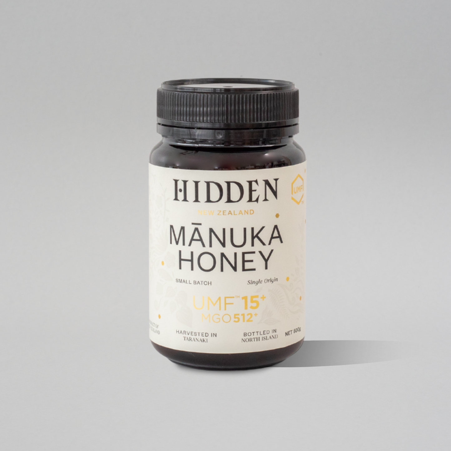 Jar of WellNest UMF15+ Manuka Honey with MGO512+ label, 500g container showing golden honey inside.