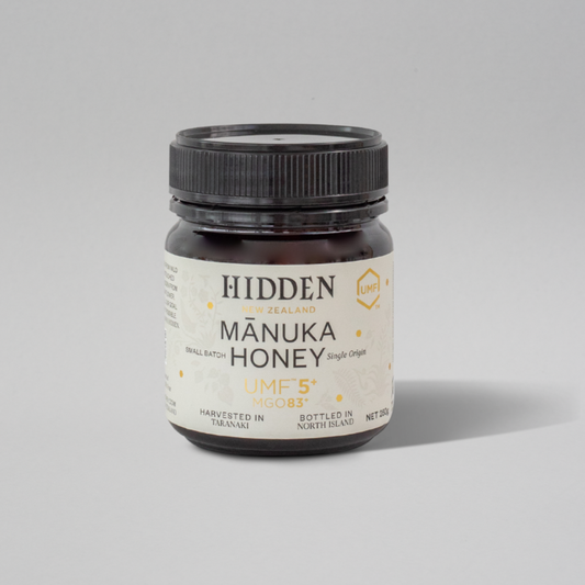WellNest UMF5+ Manuka Honey in 250g jar, showing golden honey with labeling indicating MGO83+ and UMF5+ certification.
