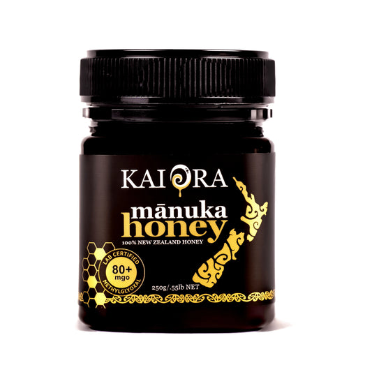 Jar of WellNest Kai Ora Black Label Manuka Honey with 80+ MGO, showcasing golden honey in a glass jar.