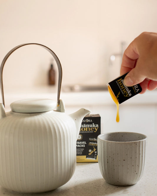 WellNest MGO 510+ Manuka Honey travel packs, 12 snap packs of 60g each, featuring golden honey in convenient portable sachets.