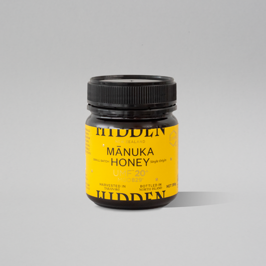 Jar of WellNest UMF20+ Manuka Honey with MGO829+ in a 250g container, showcasing the golden honey inside.