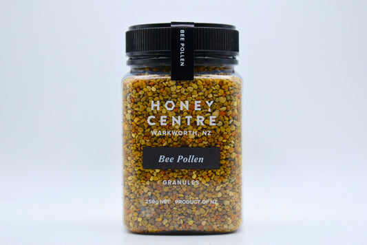 WellNest bee pollen granules in a clear jar, showing golden-yellow pollen granules for natural health supplementation.